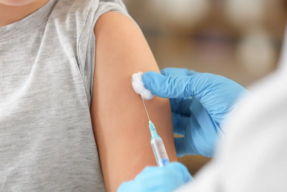 Close-up-of-medical-professional-administering-vaccine-in-persons-arm