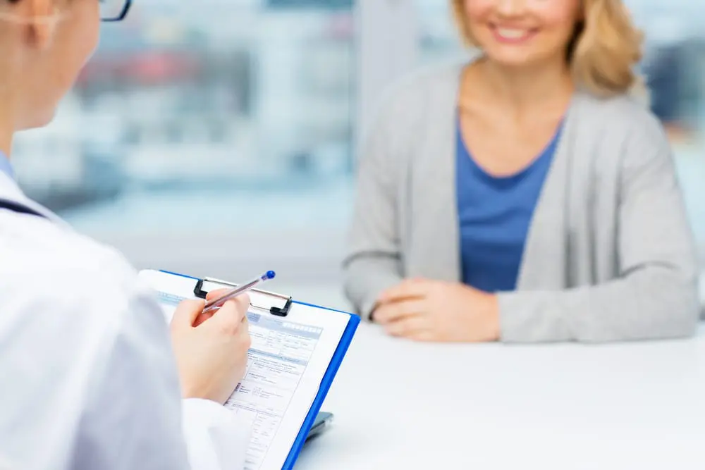 smiling-woman-talking-to-healthcare-professional