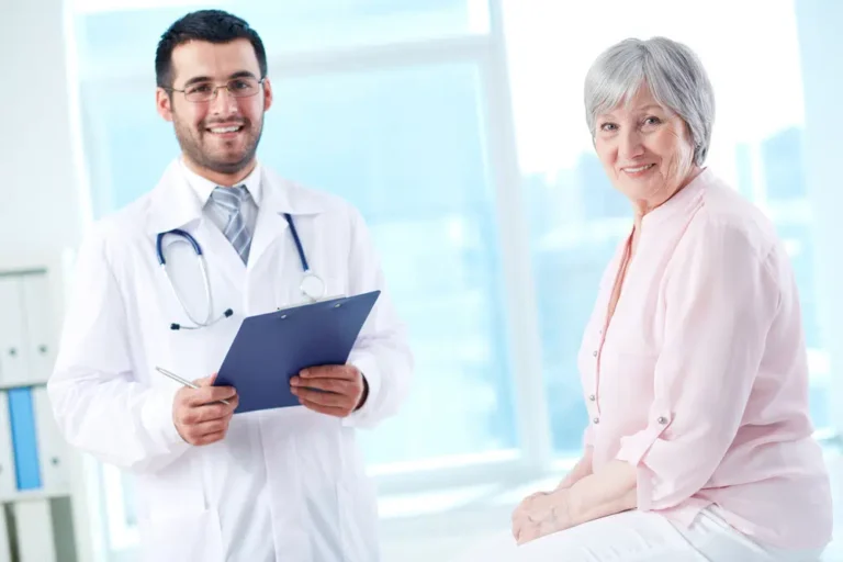 Smiling-male-doctor-and-senior-female-patient