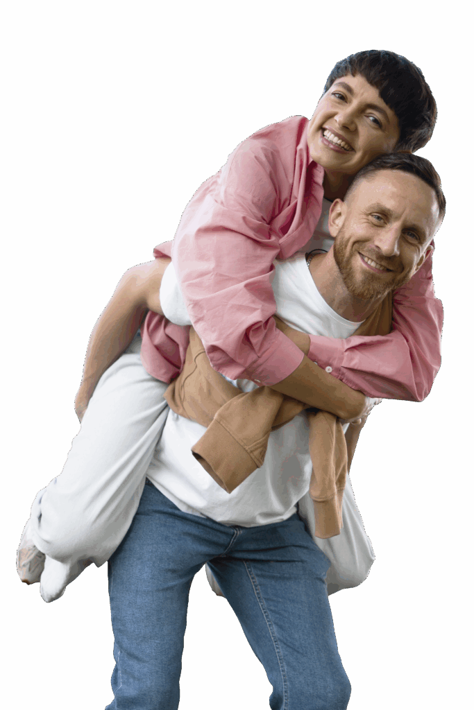 Man giving woman a piggie back ride while they are smiling
